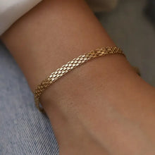 Gold bracelet on a wrist