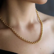 14k Gold Plated chain necklace on a person's neck 