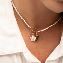 Pearl Necklace With a Charm Worn